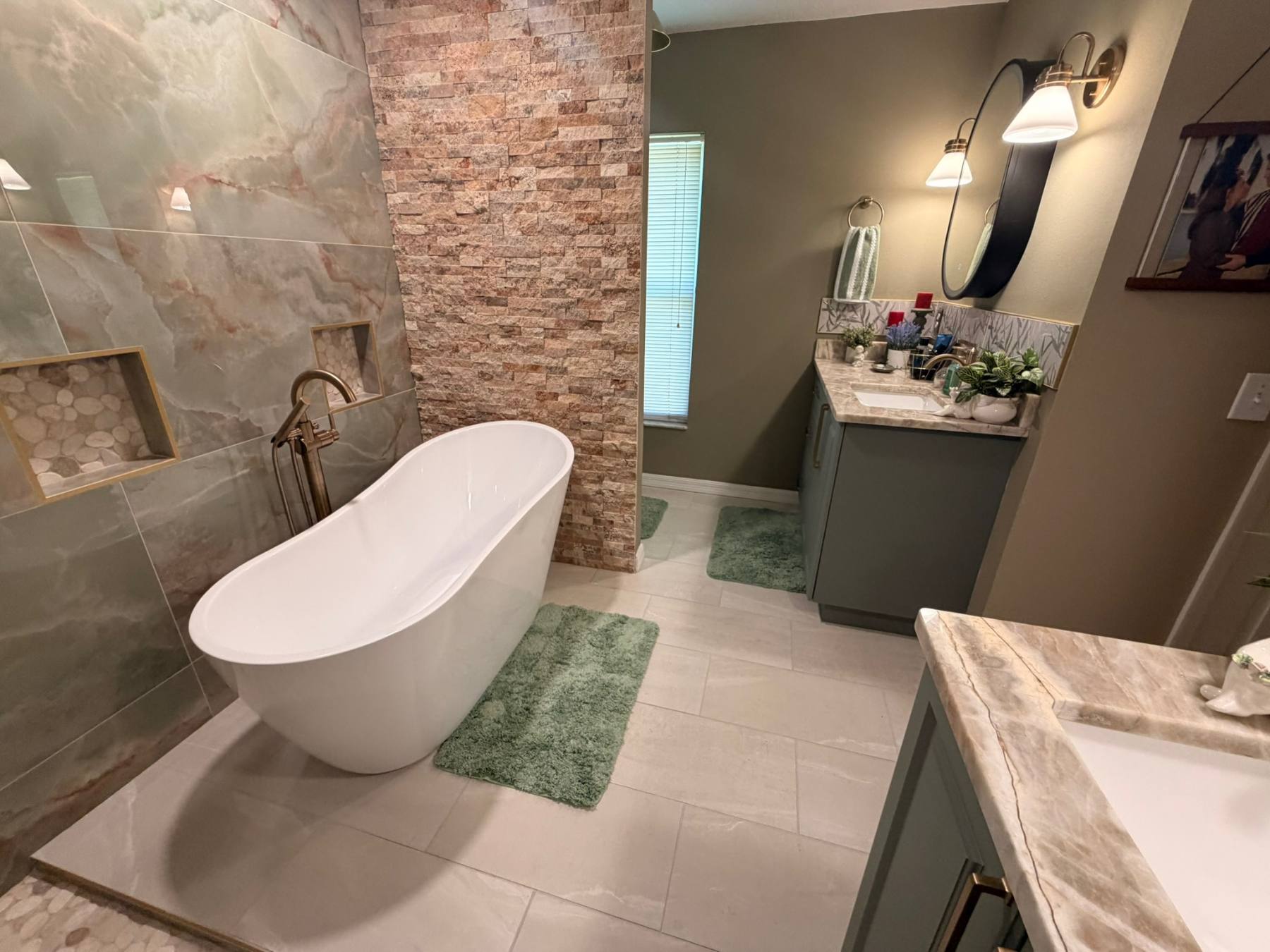 Freestanding tub and brick wall