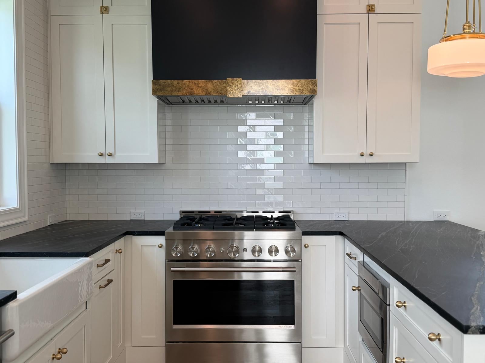 White shaker kitchen with black soapstone countertops