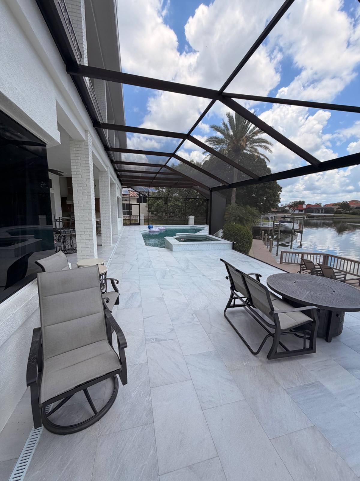 Waterfront paver patio with pool