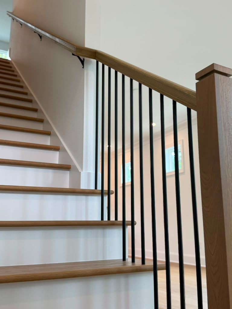 Oak staircase with black iron balusters